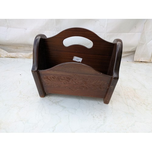 526 - An oak newspaper stand with floral carvings