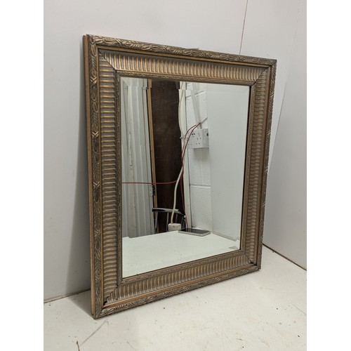 438 - A bevelled edge mirror in an ornate gilt frame