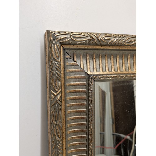 438 - A bevelled edge mirror in an ornate gilt frame