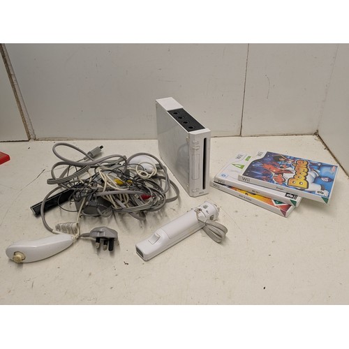 1219 - A Nintendo Wii console with cables, controllers and a selection of games