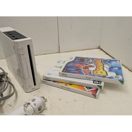 1219 - A Nintendo Wii console with cables, controllers and a selection of games