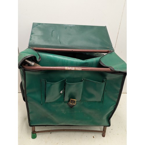 36 - A metal framed canvas tackle bag with a vintage fishing net