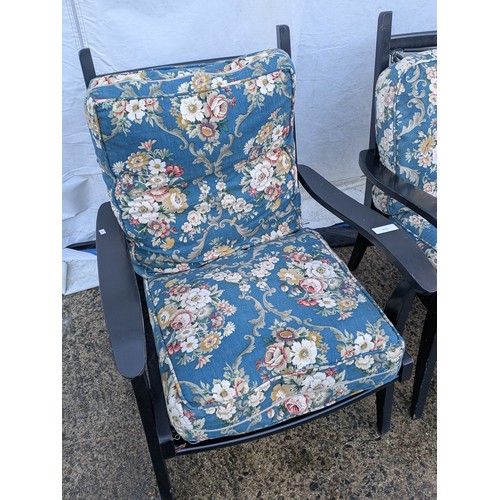 412 - A pair of painted conservatory chairs with blue floral patterned cushions