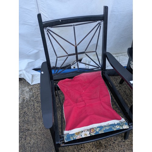 412 - A pair of painted conservatory chairs with blue floral patterned cushions