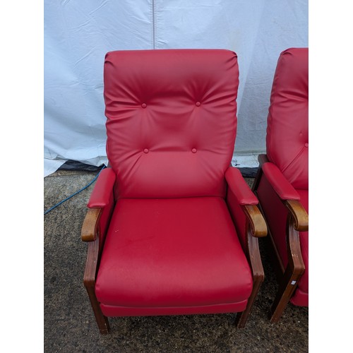 421 - A pair of retro style reclining armchairs with a pine frame and red vinyl upholstery