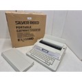 A retro Silver Reed EX133MD portable electric typewriter in original box