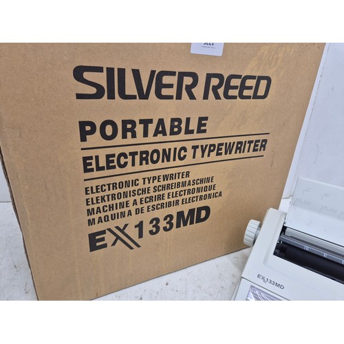 A retro Silver Reed EX133MD portable electric typewriter in original box