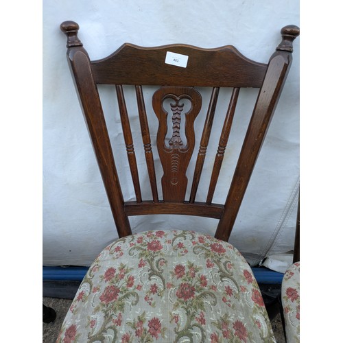 403 - A set of 4 oak dining chairs with floral padded seat bases