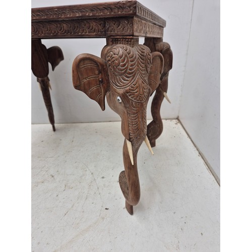 404 - An interesting intricately carved occasional table with elephant's heads as legs