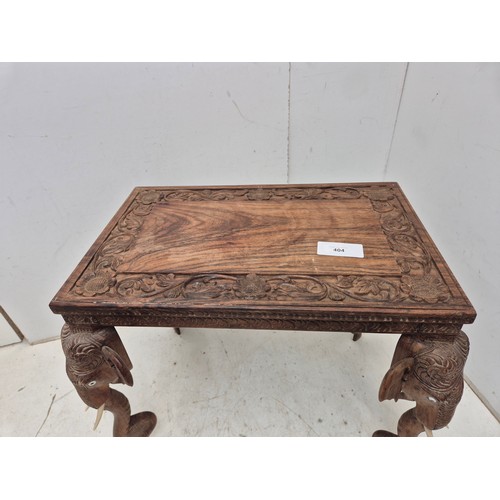 404 - An interesting intricately carved occasional table with elephant's heads as legs