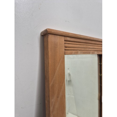 402 - A small pine framed wall mounted mirror