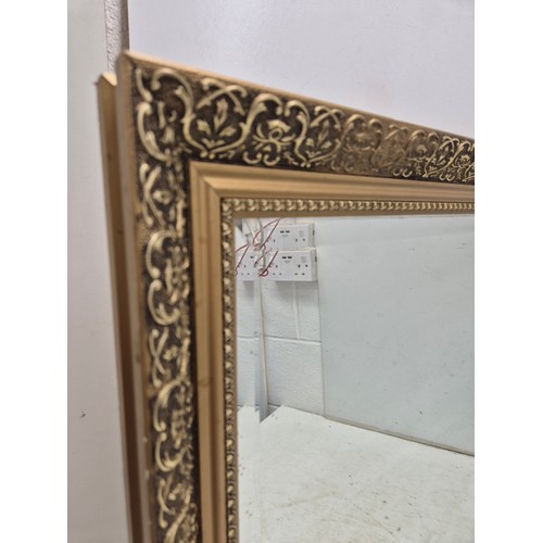 400 - A quality bevelled edge mirror in an ornate gilt frame