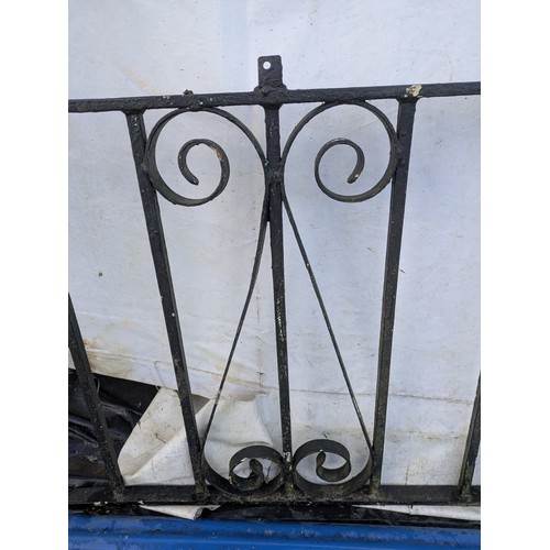 64 - A black wrought iron garden gate