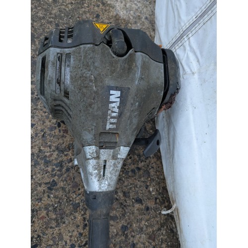 94 - A Titan petrol strimmer with a variety of attachments