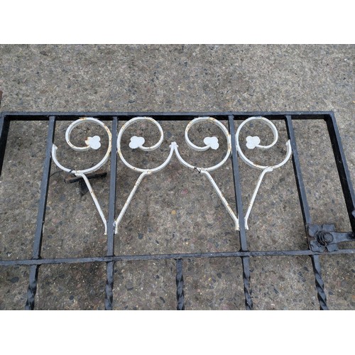 210 - A wrought iron gate with floral details