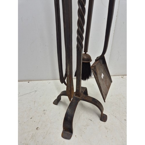 1021 - A set of wrought iron fire side tools