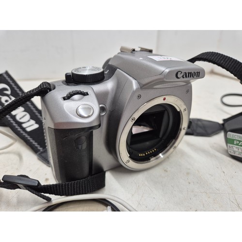 1455 - A Canon DS126071 digital camera with charger, battery, manuals and accessories - powers on