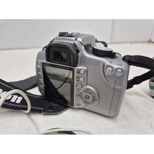 1455 - A Canon DS126071 digital camera with charger, battery, manuals and accessories - powers on