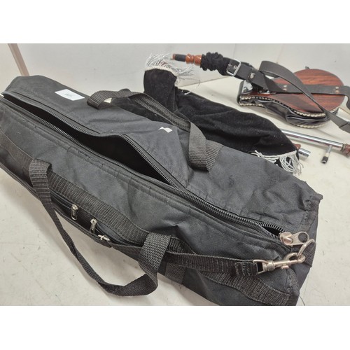 2071 - A set of black and silver bagpipes on carry case