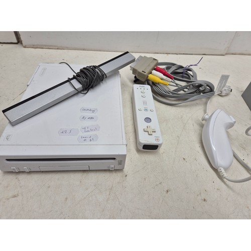 1402 - A Nintendo Wii console with cables and controller