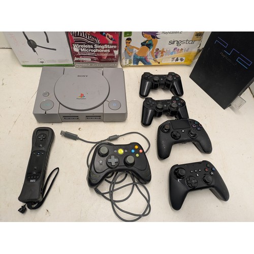 1441 - A selection of games consoles and controllers including PS3 and Nintendo Wii remote