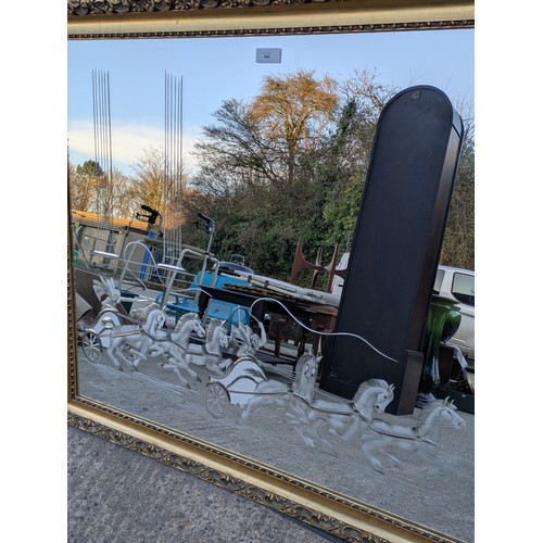 464 - A large wall hanging mirror, etched with a chariot scene in a golf Gilt ornate frame