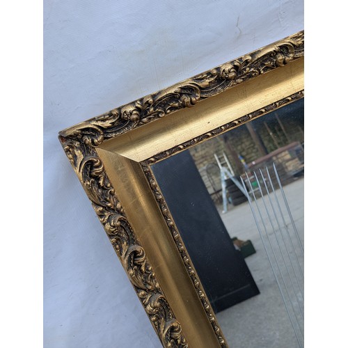 464 - A large wall hanging mirror, etched with a chariot scene in a golf Gilt ornate frame