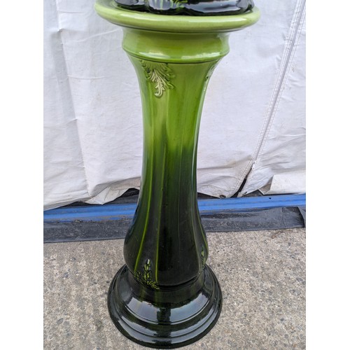 463 - A porcelain plant pot with matching green vase stand