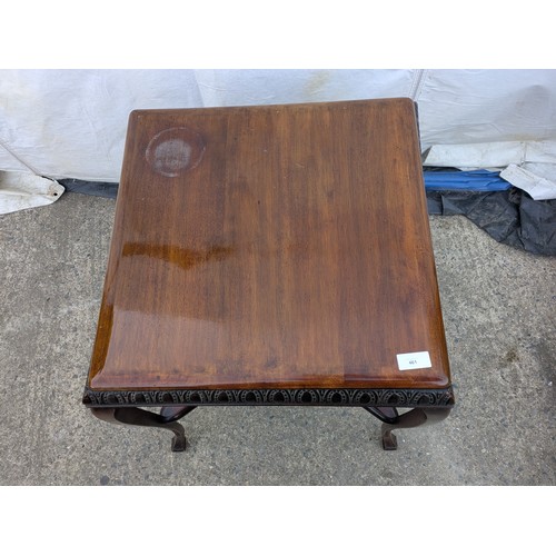 461 - An antique mahogany table with cabrio legs and horseshoe carvings