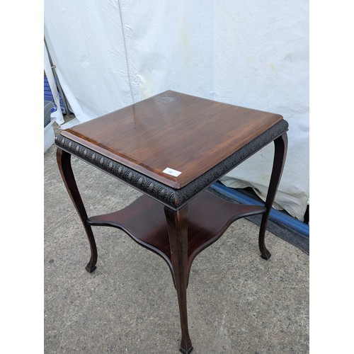 461 - An antique mahogany table with cabrio legs and horseshoe carvings