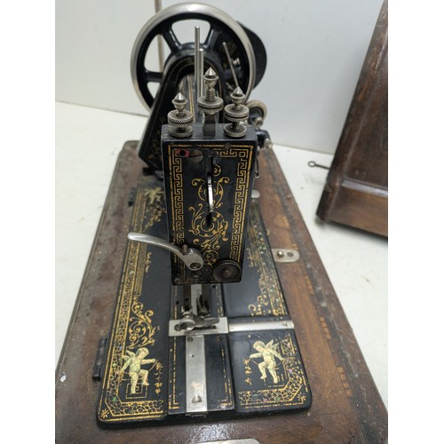 1015 - Antique Victa hand crank sewing machine in a wooden case