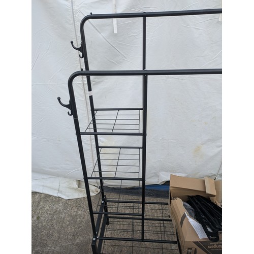 604 - A metal clothes and shoe rack, with a selection of clothes hangers