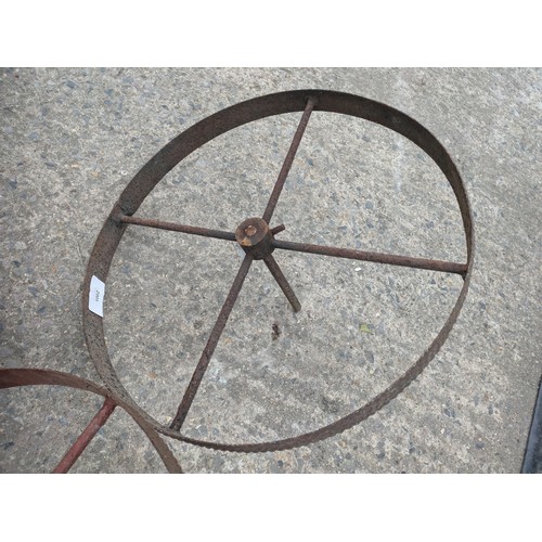 1002 - A pair of wrought iron trolley wheels