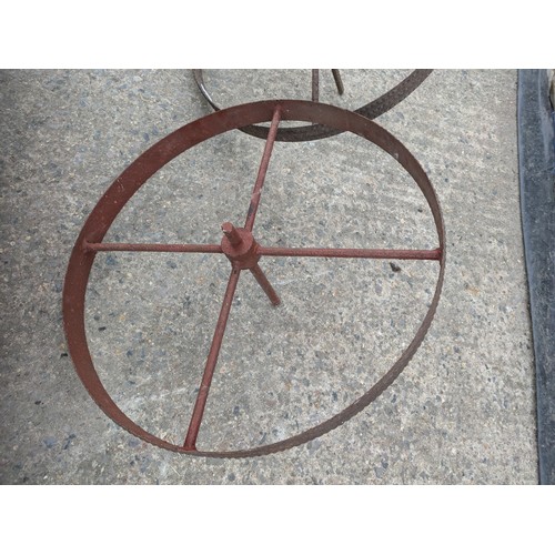 1002 - A pair of wrought iron trolley wheels