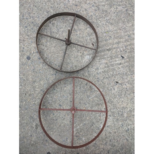 1002 - A pair of wrought iron trolley wheels