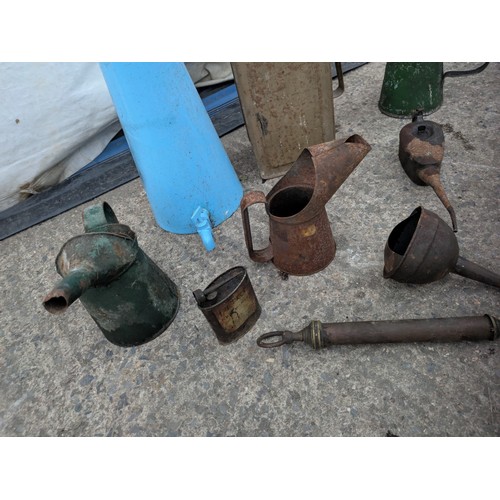 1006 - Selection of various oil and paraffin cans, including one Esso blue can.