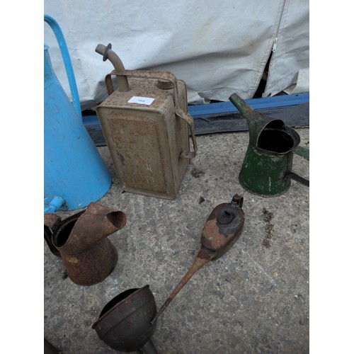 1006 - Selection of various oil and paraffin cans, including one Esso blue can.