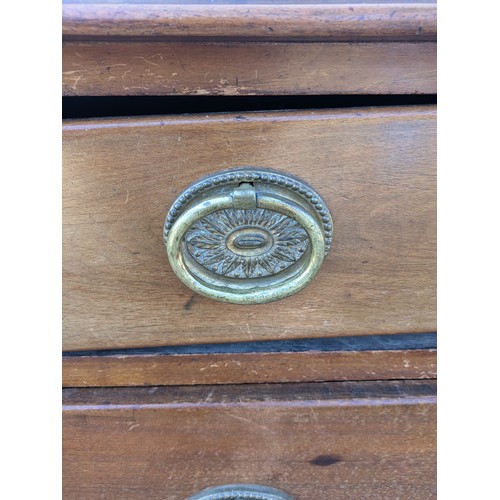 473 - An early 20th century Mahogany graduating chest of drawers with ornate brass handles - in need of ge... 