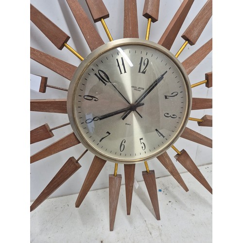 627 - A retro sunburst style quartz wall clock by Anstey Wilson.