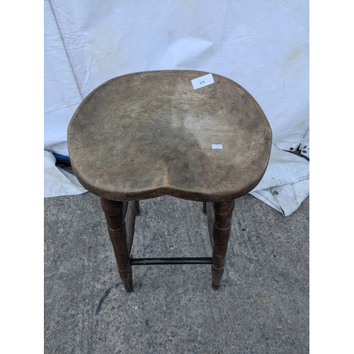 479 - A rustic carved stool with turned legs