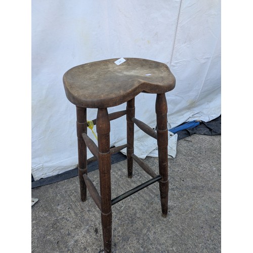 479 - A rustic carved stool with turned legs