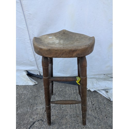 479 - A rustic carved stool with turned legs