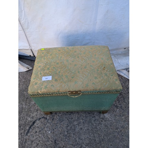 482 - A wicker storage box with a padded Florally upholstered seated top