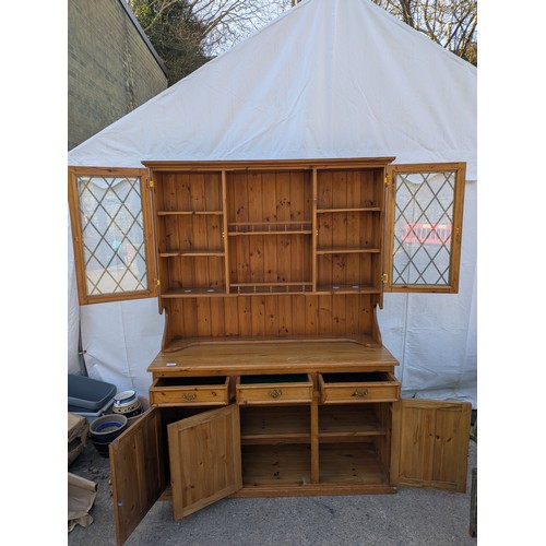 626 - A pine Welsh dresser, with a glass fronted display cabinet and underlying drawers and storage compar... 