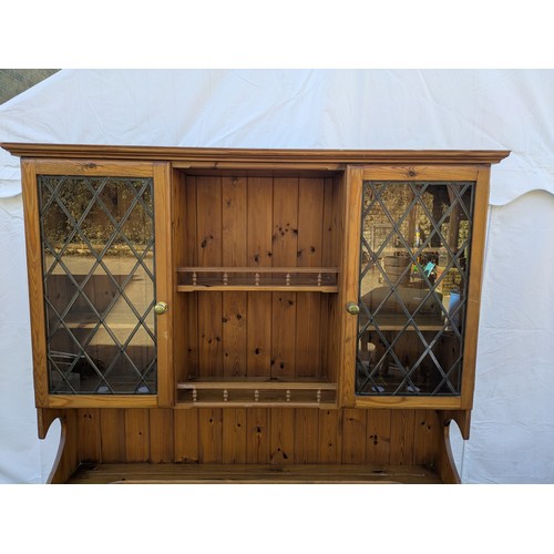 626 - A pine Welsh dresser, with a glass fronted display cabinet and underlying drawers and storage compar... 