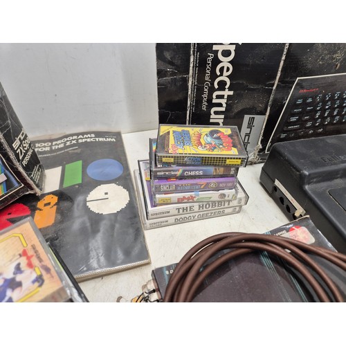 1452 - A selection of retro Sinclair ZX Spectrum equipment including boxes, games, manuals, and a Fuller sy... 