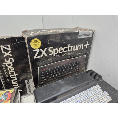 1452 - A selection of retro Sinclair ZX Spectrum equipment including boxes, games, manuals, and a Fuller sy... 