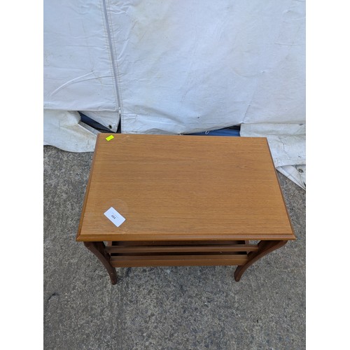 484 - A retro side table with underlying newspaper rack