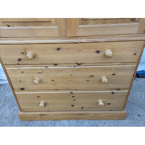 471 - A large pine upright wardrobe - 3 underlying drawers with a large wardrobe space and interior clothe... 