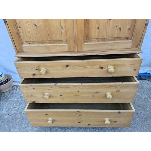 471 - A large pine upright wardrobe - 3 underlying drawers with a large wardrobe space and interior clothe... 